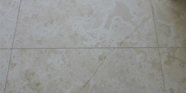 Travertine Cracked tile before it is repaired.
